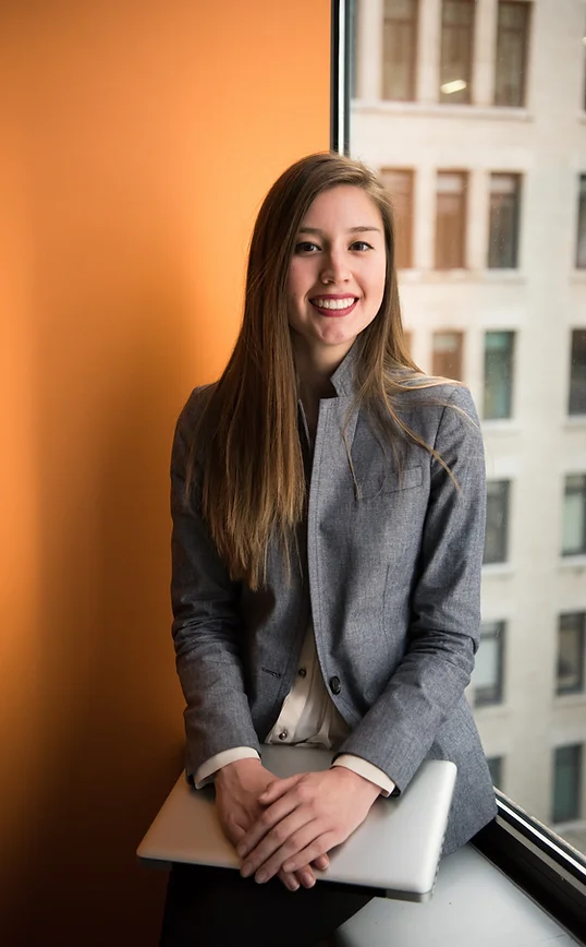 a woman sitting on a window sill in an office building