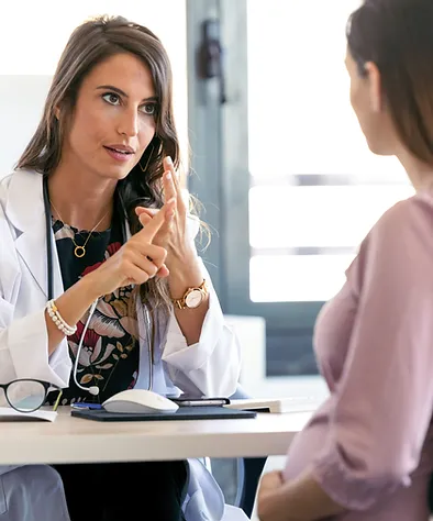 a woman talking to a pregnant woman