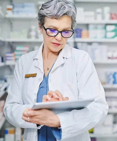 a woman in a white coat using a tablet