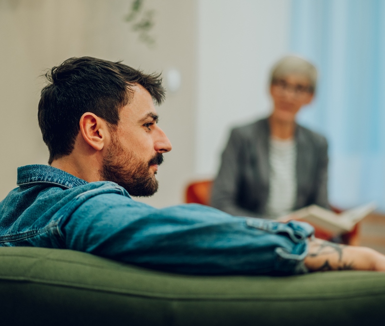 young man speaking with therapist